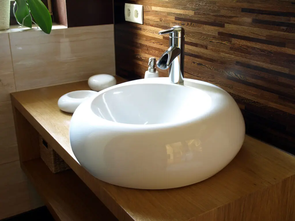 Closeup of round white sink in modern bathroom